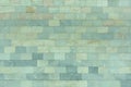 The wall is made of marble blue and turquoise tiles. Beautiful stone texture. Empty background.