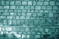 Wall made of old stones in cyan tone