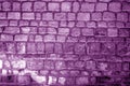 Wall made of old stones in purple tone