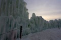 A wall made out of frozen blocks of ice and icicles towering against the sky, at dusk, at Ice Castles in Lake Geneva Royalty Free Stock Photo