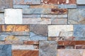 A wall made up of medium to large colored stones Royalty Free Stock Photo