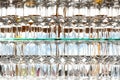 Wall of many empty transparent wine glasses on glass shelf at bar cafe or restaurant against backlit window. Abstract alcoholic Royalty Free Stock Photo
