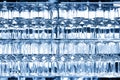 Wall of many empty transparent wine glasses on glass shelf at bar cafe restaurant against backlit window. Abstract alcoholic Royalty Free Stock Photo