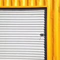 Wall of metallic sheet in yellow and white