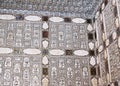 A wall with mirror mosaic and marble flowers and ceiling edge in an ancient palace Sheesh Mahal. Amber Fort, Jaipur, India