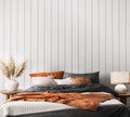 Wall mockup in coastal bright bedroom, rattan furniture and orange bedding in trendy decoration