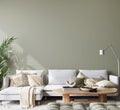 wall mockup in modern living room design, minimal white sofa on green interior background Royalty Free Stock Photo