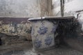 wall-mounted ceramic washbasin in old abandoned mansion