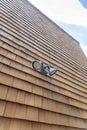 Wall-mounted dual head flood light on a wooden shingle wall at San Francisco, California