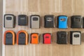 Wall mounted key lockboxes in various colors and designs on wooden surface Royalty Free Stock Photo