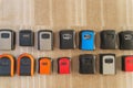 Wall mounted key lockboxes in various colors and designs on wooden surface Royalty Free Stock Photo