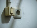 a wall-mounted light switch and an electrical power outlet side by side. Royalty Free Stock Photo