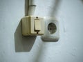 a wall-mounted light switch and an electrical power outlet side by side Royalty Free Stock Photo