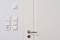 Wall-mounted light switches and roller shutter control switch on the windows next to the front door Royalty Free Stock Photo