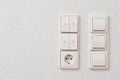 Wall mounted light switches, roller shutter control switch for closing windows and electrical outlet, close-up Royalty Free Stock Photo