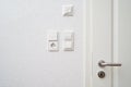 Wall-mounted light switches, roller shutter control switch on the windows and temperature control wheel next to the Royalty Free Stock Photo