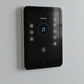 A wall-mounted smart home control panel with a sleek, rectangular design and rounded edges Royalty Free Stock Photo