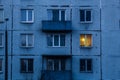 Wall of multi-storey residential building with Iluminated window. Royalty Free Stock Photo