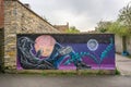 Wall mural of hooded reclining teenager - fantasy scene - in Glastonbury, Somerset, UK