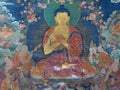 Wall mural painting of The Buddha in Dharmchakra Teaching of The Wheel of Dharma mudra or pose, Jokhang Temple, Lhasa, Tibet