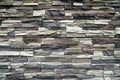 Wall of narrow flat stones in brown, gray,beige colors