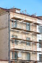 Wall of old apartment building with scaffolding. facade reconstruction Royalty Free Stock Photo