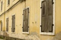 Wall of old building with window with closed wooden shutters Royalty Free Stock Photo