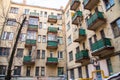 wall of an old high-rise building with green balconies. Royalty Free Stock Photo