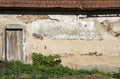 The wall of an old house with a door