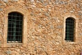 The wall of an old house with two windows. Royalty Free Stock Photo