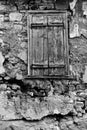 Wall of old house with window closed by shutters Royalty Free Stock Photo