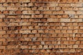 Wall of old orange clay bricks. Ruined vintage stone background. Rough aged masonry backdrop. Surface of grunge brick Royalty Free Stock Photo