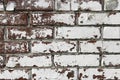 Wall from old and peeling brick, full frame use for background. Shabby and faded white paint on a brick wall Royalty Free Stock Photo