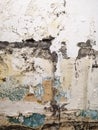 A wall with old, peeling paint. An old, shabby wall. The background is an old wall, paint peeled off. Royalty Free Stock Photo