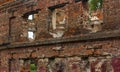 Wall of an old red brick house, ruined building