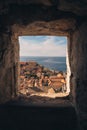 A wall opening with a view of a cityscape by the sea in the background in Croatia, Dubrovnik Royalty Free Stock Photo