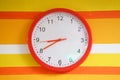 Wall orange clock on colorful