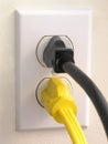Wall Outlet - Black Yellow Plug Royalty Free Stock Photo