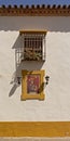 Wall painting of jesus carying the cross under the window of a house in Cordoba