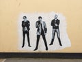 Wall painting of the pop group Muse by Mos Shaw on a wall in Teignmouth