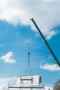 A wall part of a prefabricated house on a crane against blue sky Royalty Free Stock Photo