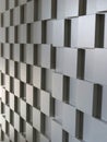 A wall with a pattern of white cubes arranged in a grid formation Royalty Free Stock Photo