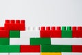 Wall from plastic building blocks isolated on a white background. Background from multi-colored details of a children`s Royalty Free Stock Photo