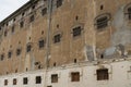 Wall of prison building with windows of pricon cells with bars Royalty Free Stock Photo