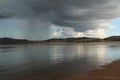 Wall of rain over the sea, a calm of water, stormy clouds Royalty Free Stock Photo