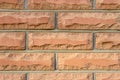 Wall of red brick. Concrete fence. Textural background. Royalty Free Stock Photo