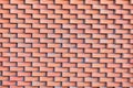 A wall of red brick laid in horizontal rows.