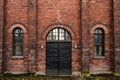 Wall of red bricks and old metal industrial doors Royalty Free Stock Photo