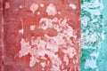 Wall with red and bright green shabby paint on white background, stripe divide on two zones