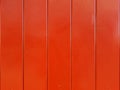 Wall of red wooden lacquered boards.